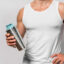 Man holding a shaker bottle filled with protein shake